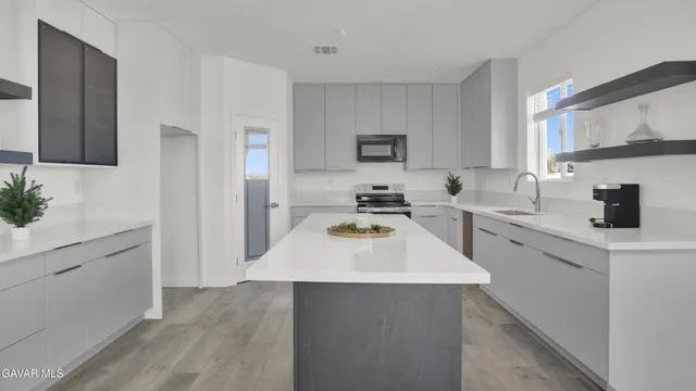 a kitchen with a sink a stove and a refrigerator