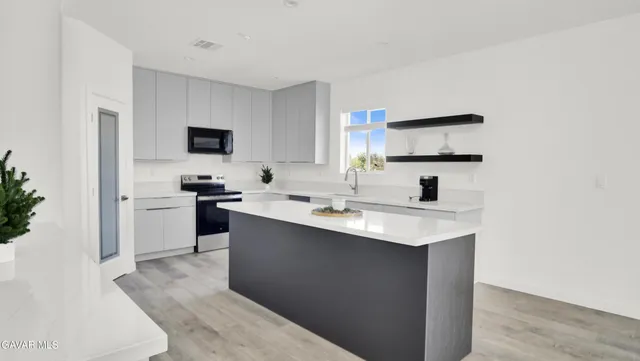 a kitchen with stainless steel appliances a sink stove and refrigerator