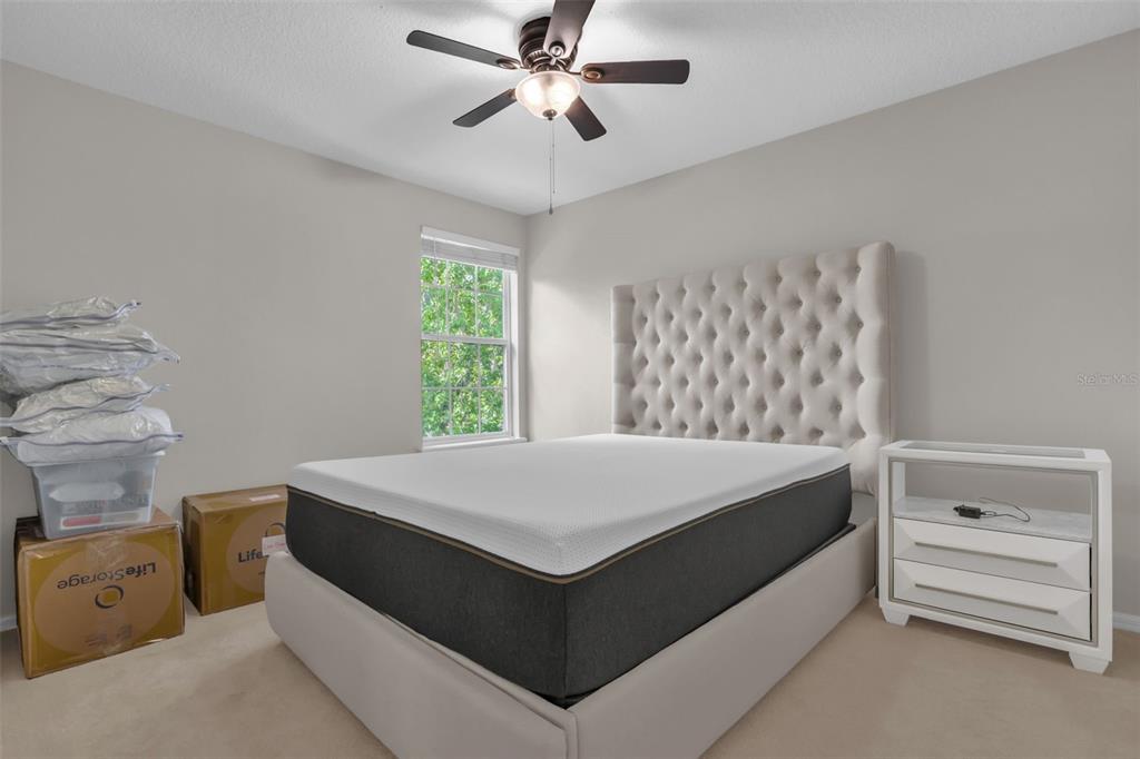 2165 Ridgewood Street Orlando, FL 32803 - Photo 24 of 37 a room with a bed and a chandelier