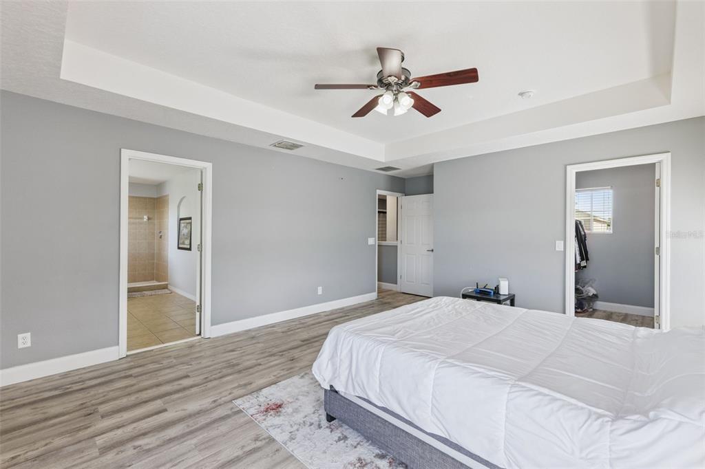 2718 Curpin Lane Orlando, FL 32825 - Photo 11 of 36 a bedroom with a large bed and wooden floor