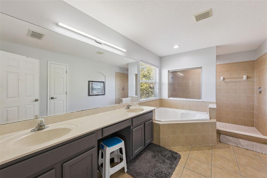 2718 Curpin Lane Orlando, FL 32825 - Photo 14 of 36 a bathroom with a tub sink and mirror