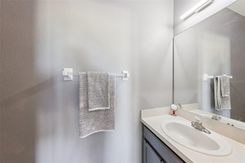 2718 Curpin Lane Orlando, FL 32825 - Photo 16 of 36 a bathroom with a sink and a mirror