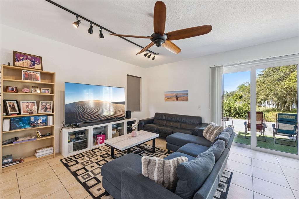 2718 Curpin Lane Orlando, FL 32825 - Photo 3 of 36 a living room with furniture and a flat screen tv