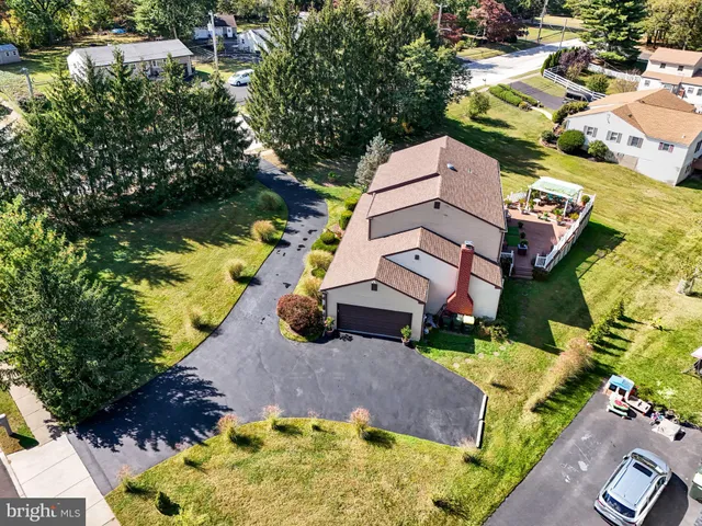 an aerial view of multiple houses with yard