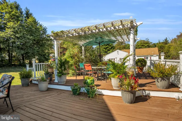 a spacious bathroom with a granite countertop sink a toilet a mirror and bathtub
