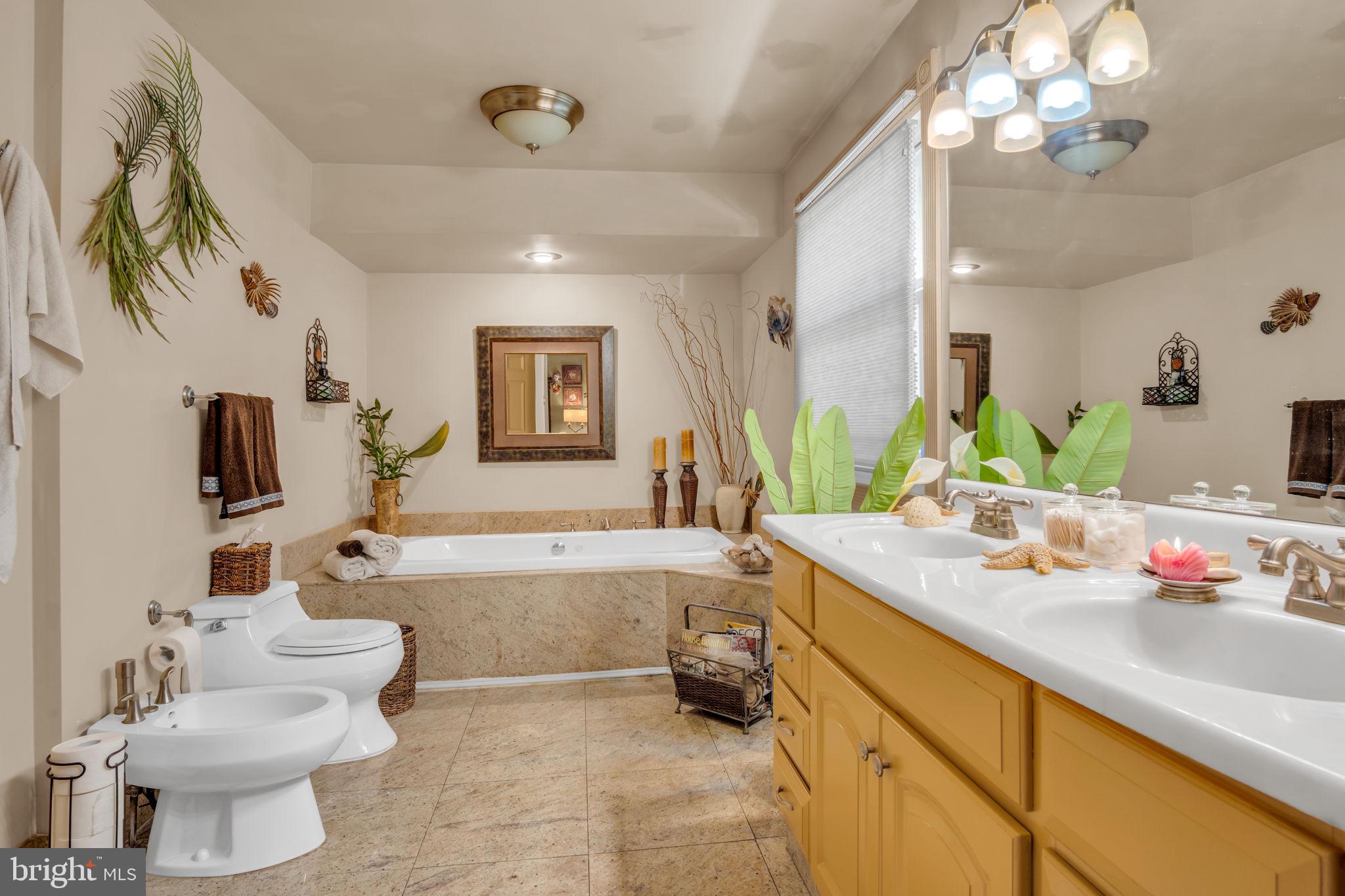 4280 Frontier Road Hatboro, PA 19040 - Photo 35 of 62 a spacious bathroom with a granite countertop sink a toilet a mirror and bathtub