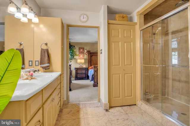 a bathroom with a granite countertop toilet sink and mirror