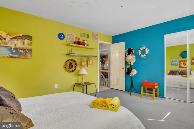 a bedroom with a bed and a dresser in it