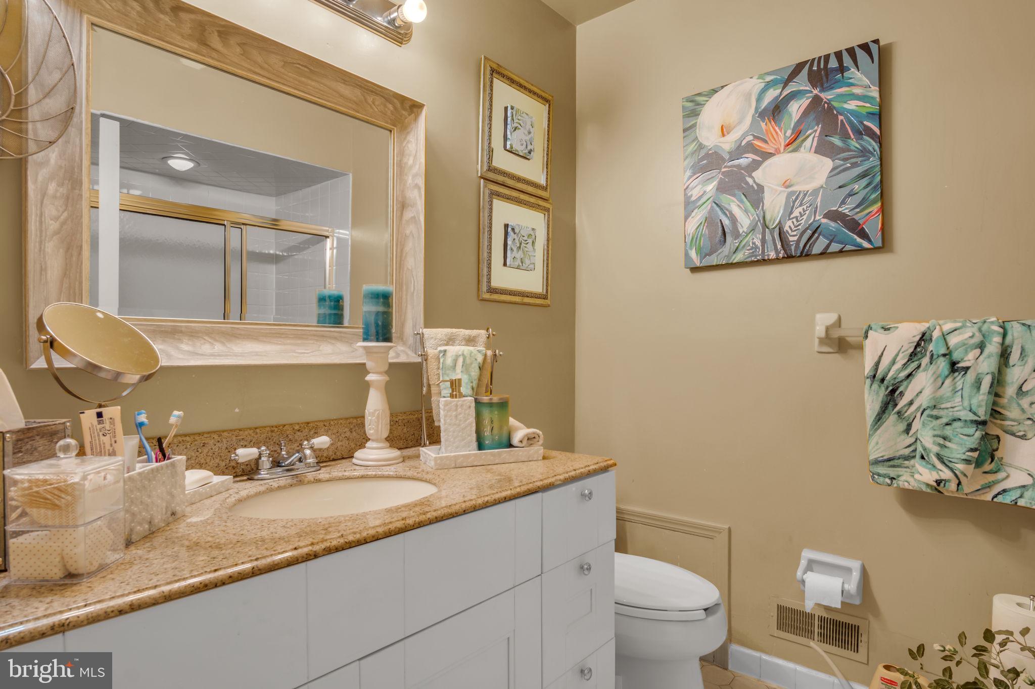 4280 Frontier Road Hatboro, PA 19040 - Photo 41 of 62 a bathroom with a granite countertop toilet sink and mirror