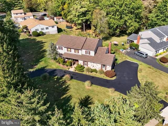 an aerial view of residential houses with outdoor space