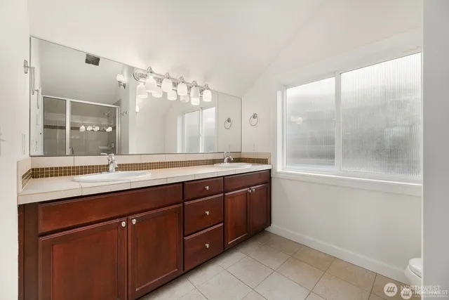a bathroom with a granite countertop sink mirror and