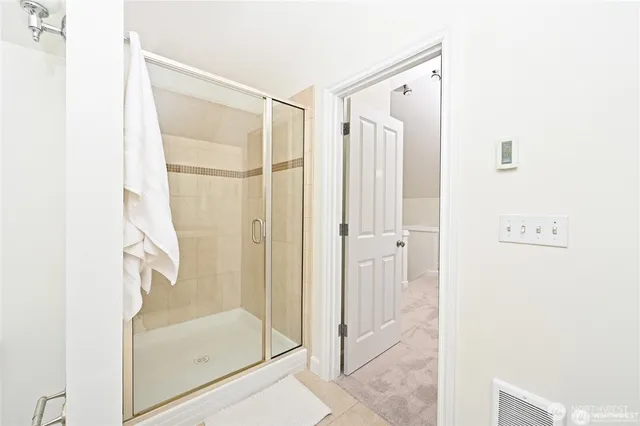 a bathroom with a glass shower door