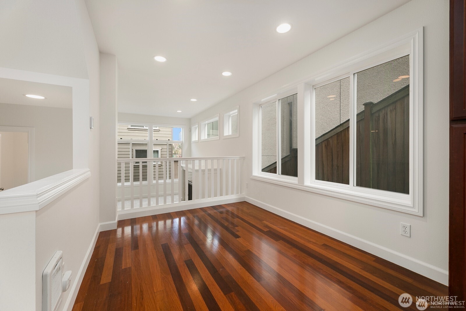 102 West Florentia Street, Unit A Seattle, WA 98119 - Photo 5 of 19 a view of an empty room with wooden floor and a window