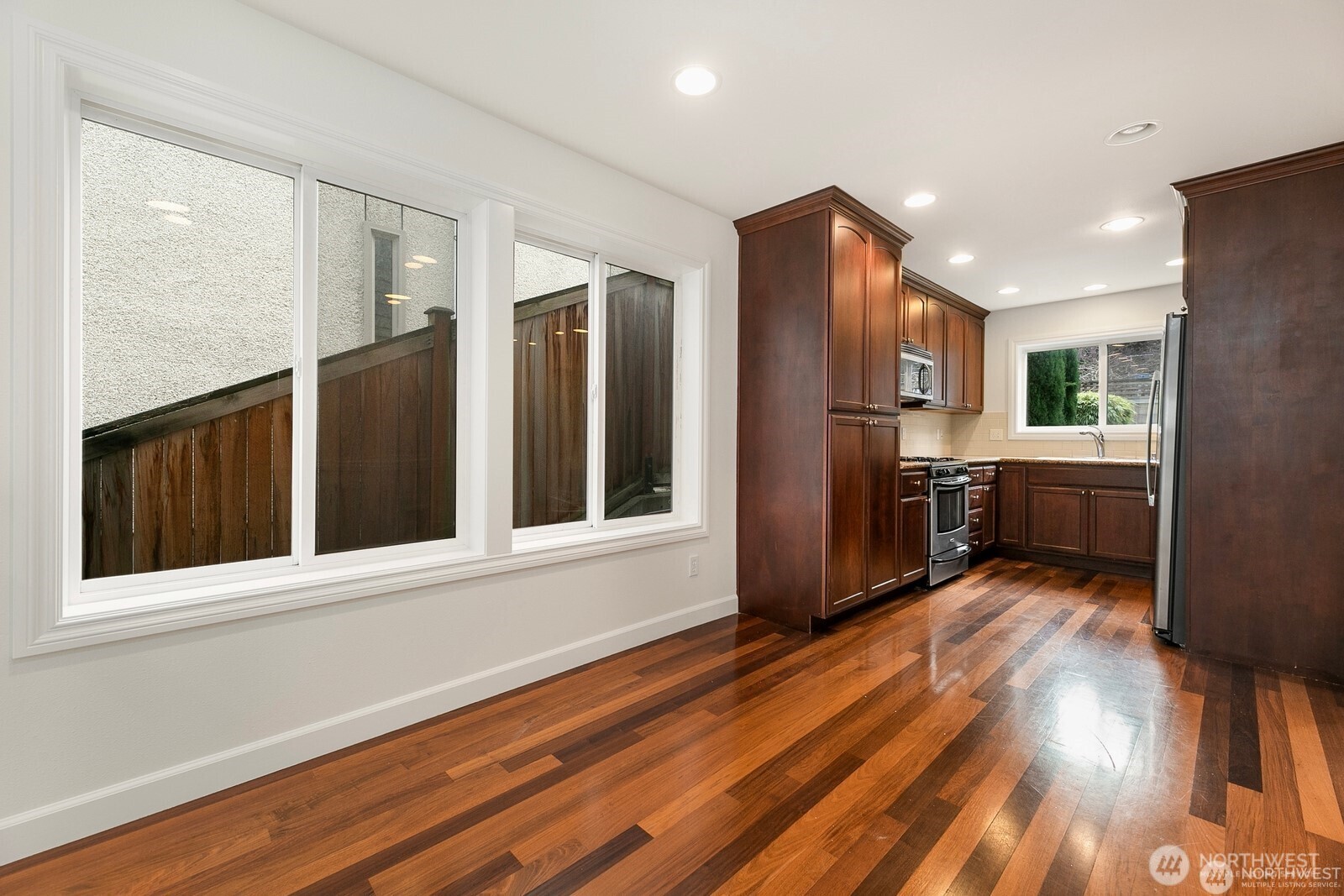 102 West Florentia Street, Unit A Seattle, WA 98119 - Photo 6 of 19 a view of a kitchen with wooden floor and electronic appliances