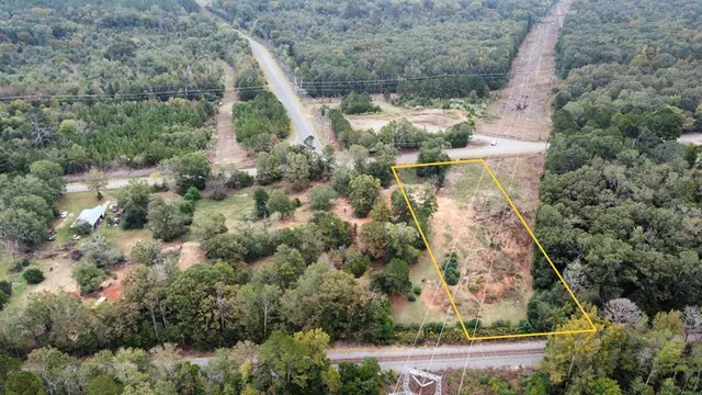a aerial view of a houses with yard