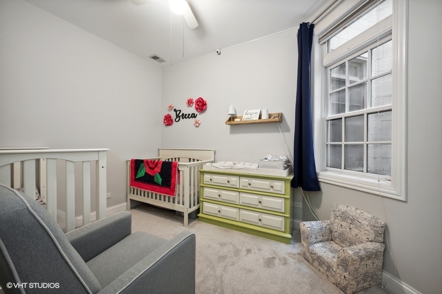 1414 West Irving Park Road, Unit 2E Chicago, IL 60613 - Photo 13 of 19 a view of a livingroom with furniture and toys