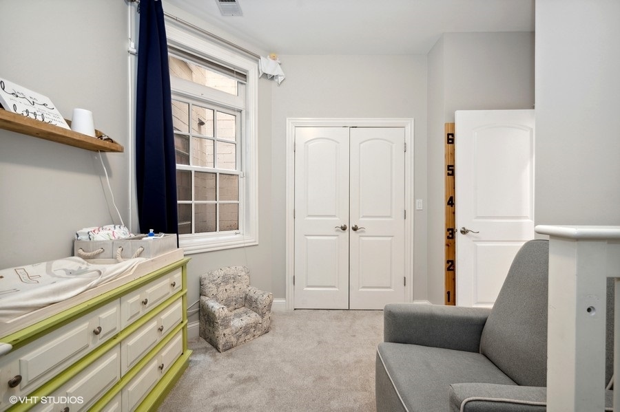 1414 West Irving Park Road, Unit 2E Chicago, IL 60613 - Photo 14 of 19 a bedroom with a bed and a window