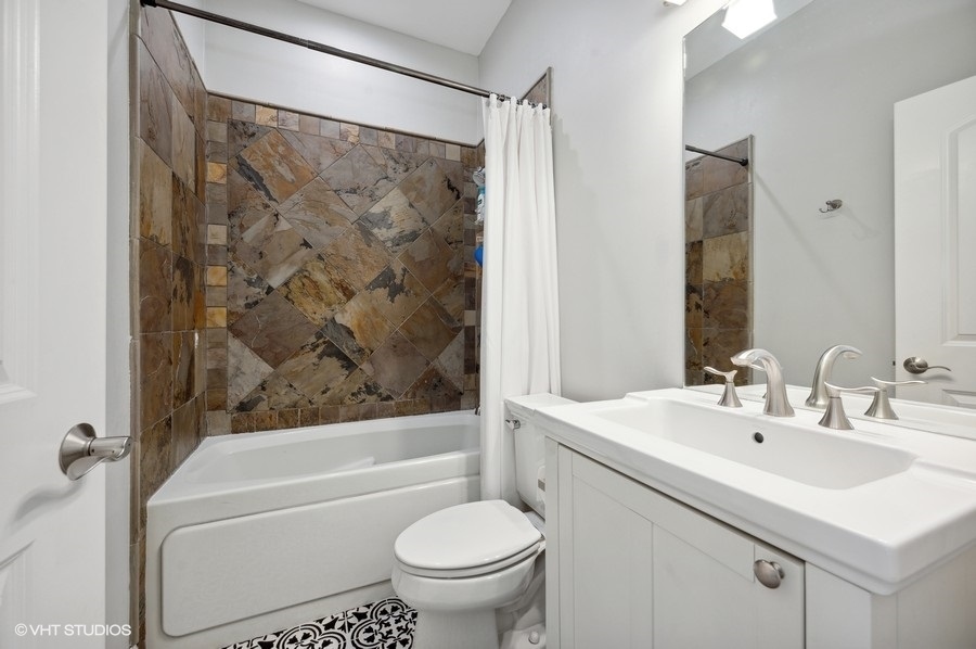 1414 West Irving Park Road, Unit 2E Chicago, IL 60613 - Photo 16 of 19 a bathroom with a sink toilet and shower