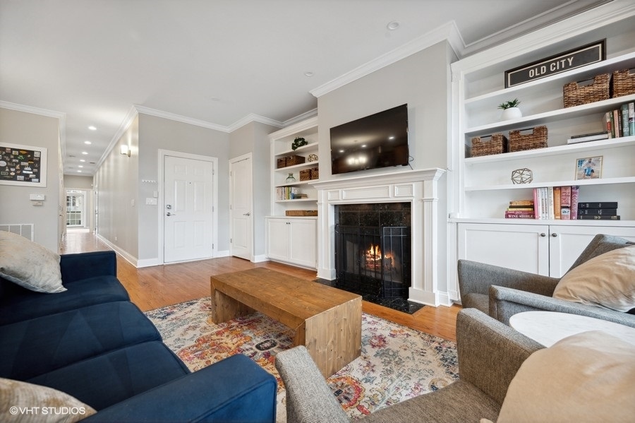 1414 West Irving Park Road, Unit 2E Chicago, IL 60613 - Photo 3 of 19 a living room with furniture and a fireplace