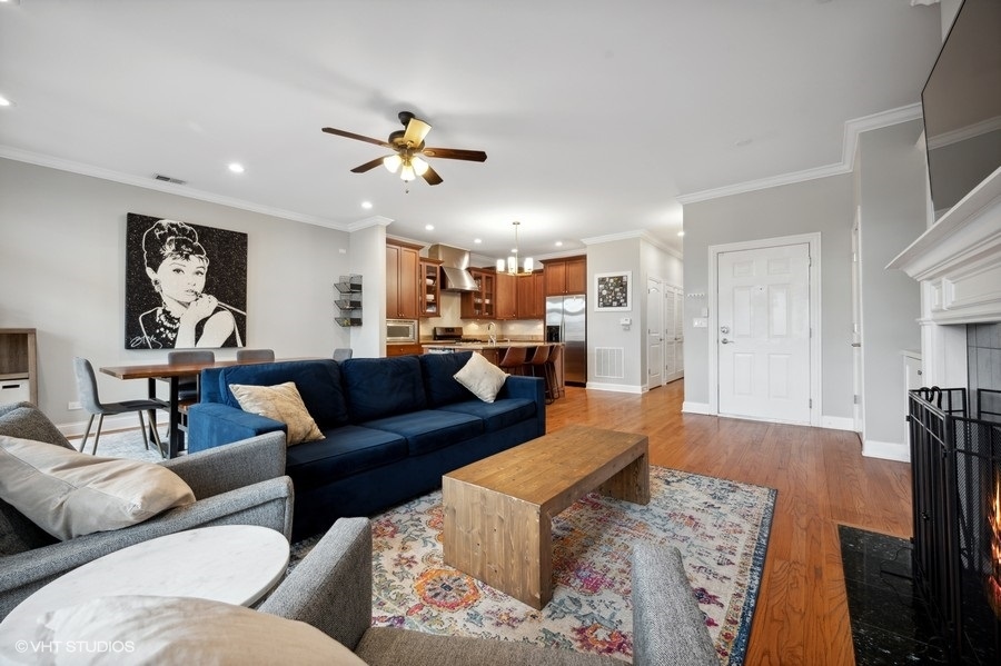 1414 West Irving Park Road, Unit 2E Chicago, IL 60613 - Photo 4 of 19 a living room with furniture and a wooden floor