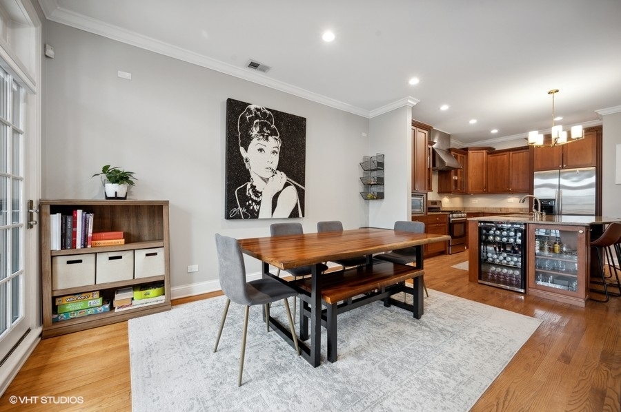 1414 West Irving Park Road, Unit 2E Chicago, IL 60613 - Photo 5 of 19 a living room with furniture kitchen view and a table