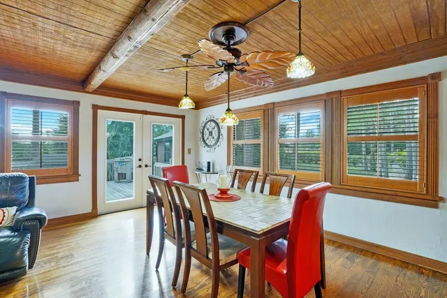 a view of a dining room with furniture wooden floor and chandelier