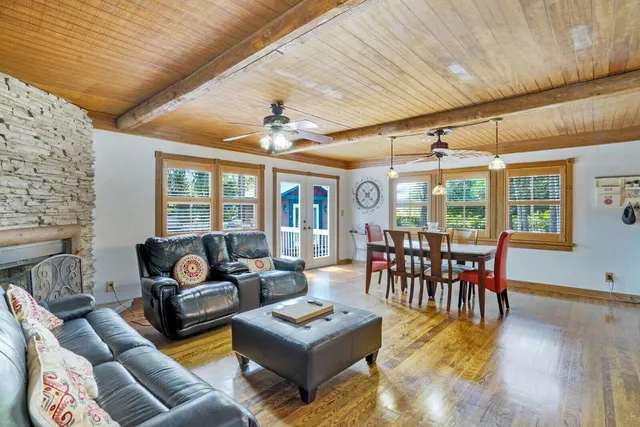 a living room with furniture a fireplace and a table