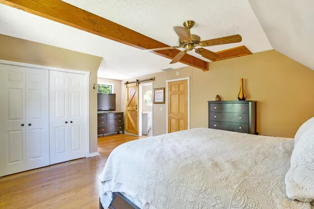 a bed room with a bed and a ceiling fan