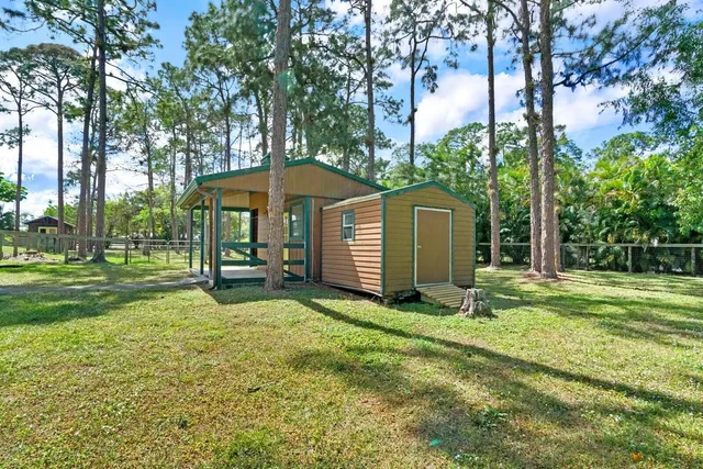 a view of a backyard with a garden and tree