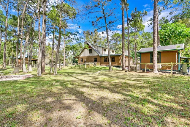 a backyard of a house with table and chairs