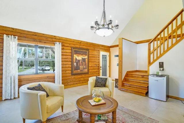 a living room with furniture and a chandelier