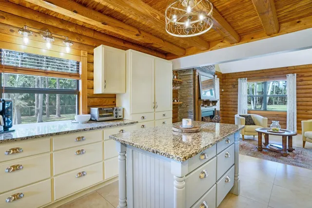 a kitchen with a stove and a large window