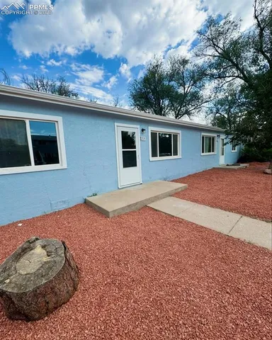 a backyard of a house with yard and outdoor seating