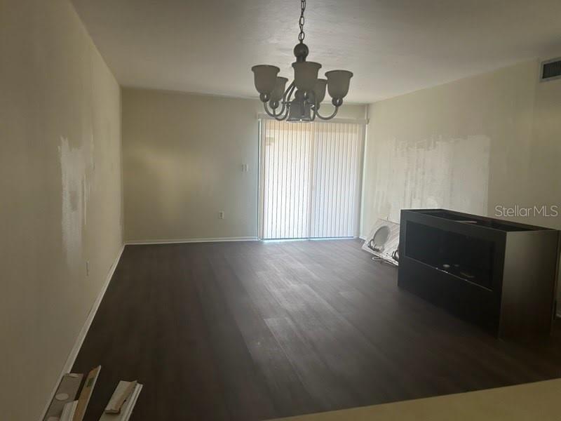 2811 Southwest Archer Road, Unit T167 Gainesville, FL 32608 - Photo 2 of 7 a view of a room with wooden floor and ceiling fan