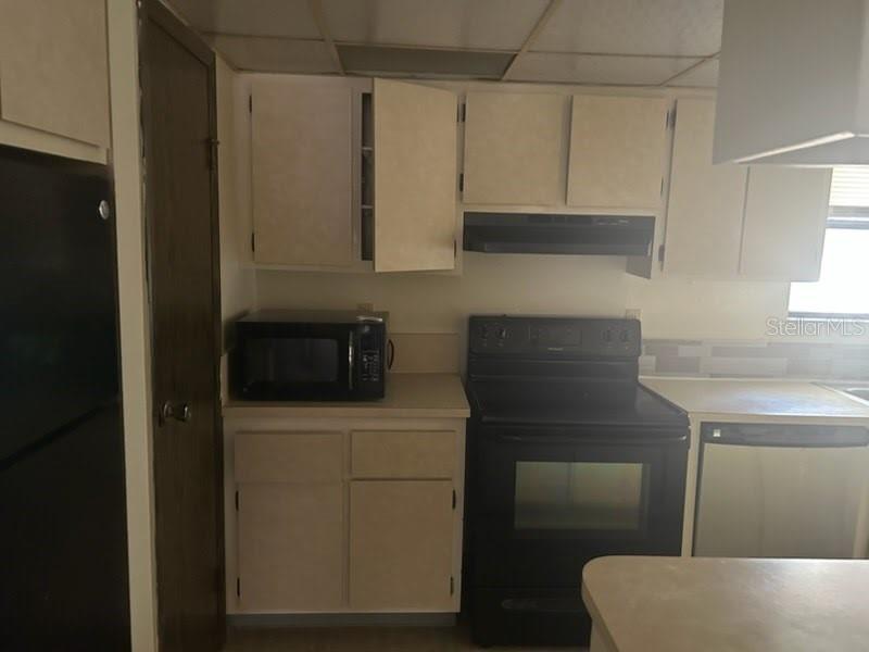 2811 Southwest Archer Road, Unit T167 Gainesville, FL 32608 - Photo 3 of 7 a kitchen with a sink and cabinets