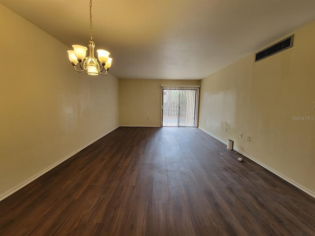 2811 Southwest Archer Road, Unit T167 Gainesville, FL 32608 - Photo 3 of 10 a view of a room with wooden floor and a ceiling fan