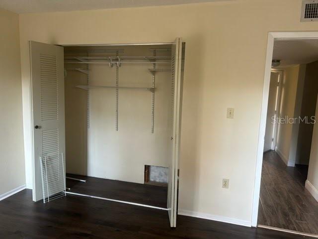 2811 Southwest Archer Road, Unit T167 Gainesville, FL 32608 - Photo 5 of 7 a room with wooden floor and a ceiling fan