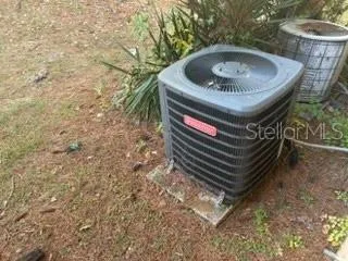 a front view of a house with a garden and trees