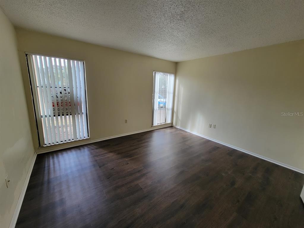 2811 Southwest Archer Road, Unit T167 Gainesville, FL 32608 - Photo 8 of 10 a view of an empty room with wooden floor and a window