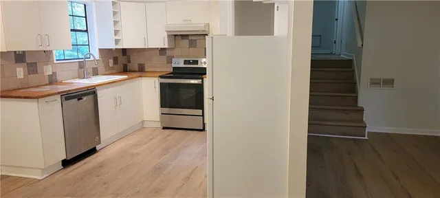a kitchen with a sink and cabinets
