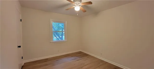 an empty room with a window and closet