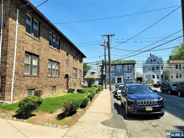 a front view of a building with sitting area