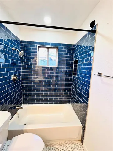 a bathroom with a sink a toilet and bathtub