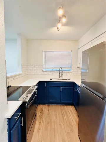 a kitchen with a sink stove and microwave