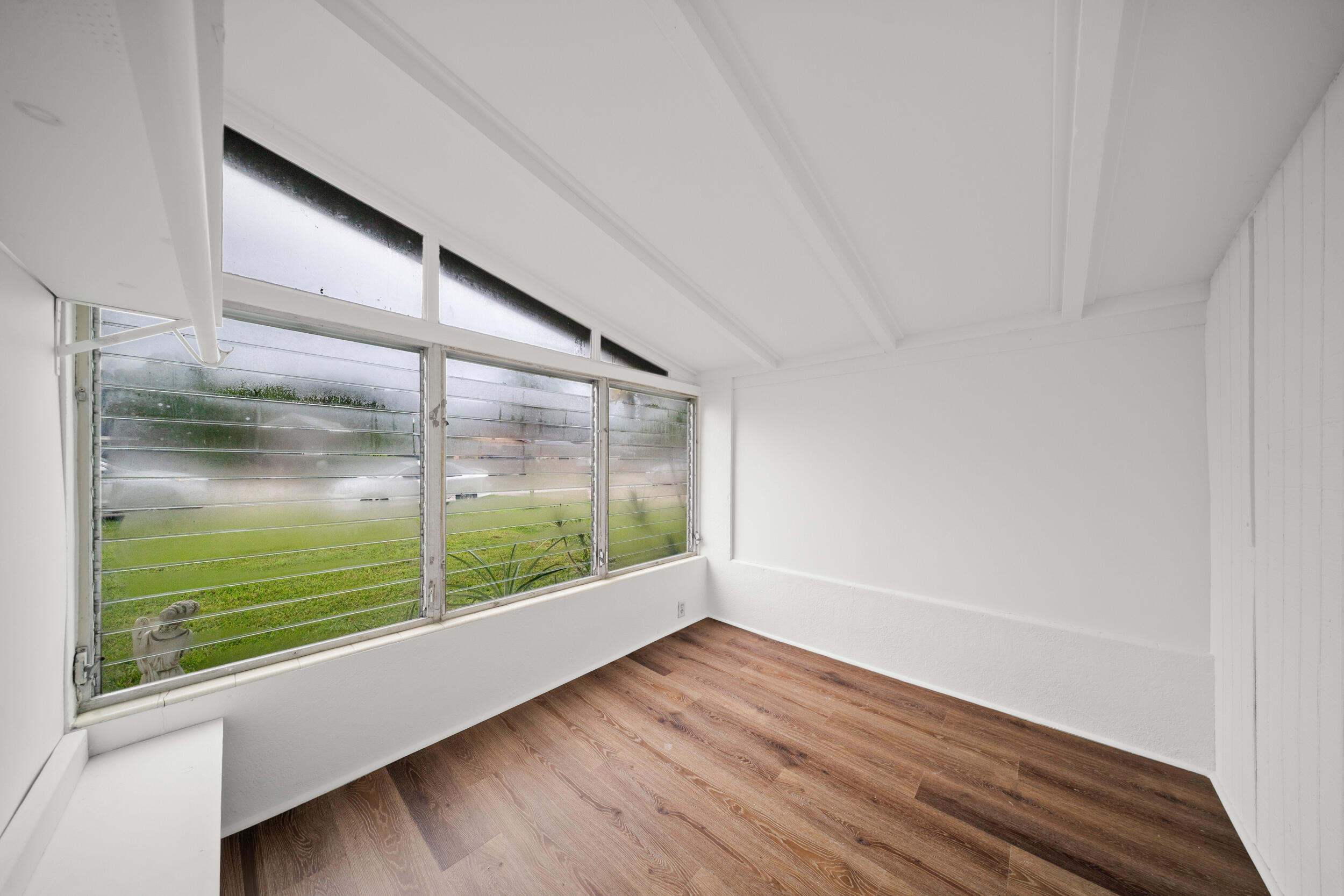 2904 Southeast Bamboo Street Stuart, FL 34997 - Photo 17 of 51 a view of a big room with wooden floor and windows