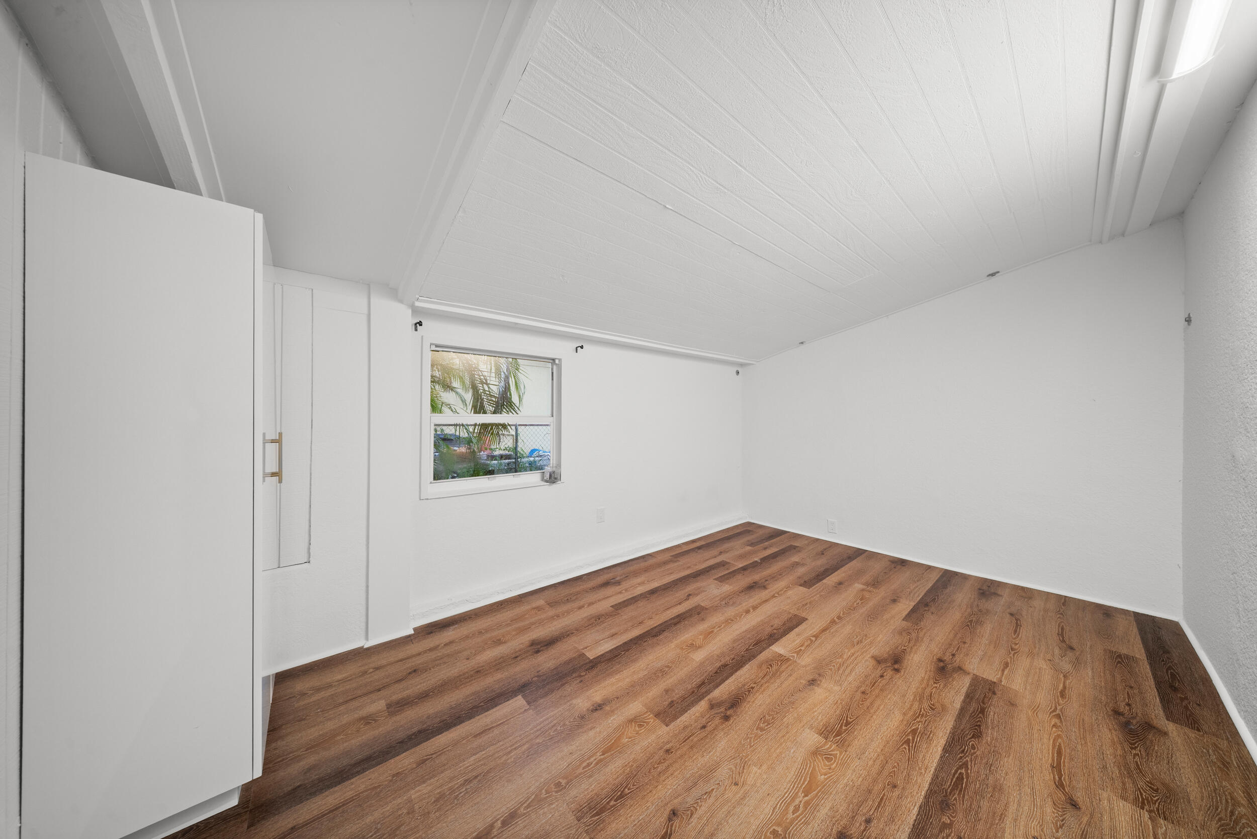 2904 Southeast Bamboo Street Stuart, FL 34997 - Photo 18 of 51 a view of empty room with wooden floor
