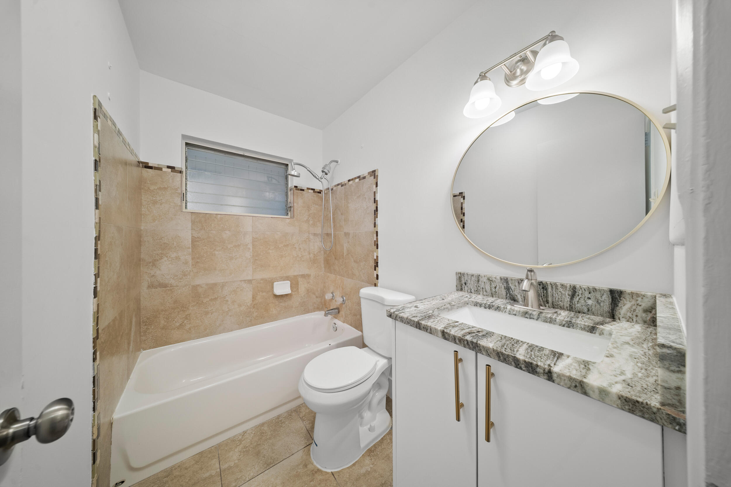 2904 Southeast Bamboo Street Stuart, FL 34997 - Photo 20 of 51 a bathroom with a granite countertop sink toilet and shower
