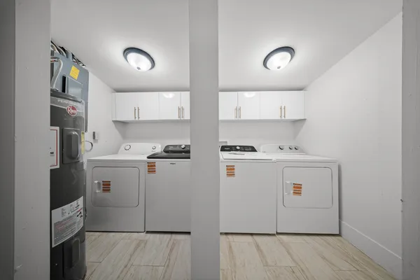 a view of a kitchen with refrigerator and window