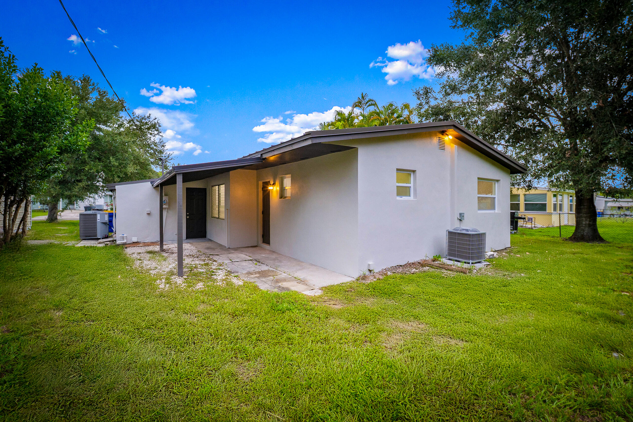 2904 Southeast Bamboo Street Stuart, FL 34997 - Photo 30 of 51 a backyard of a house with table and chairs