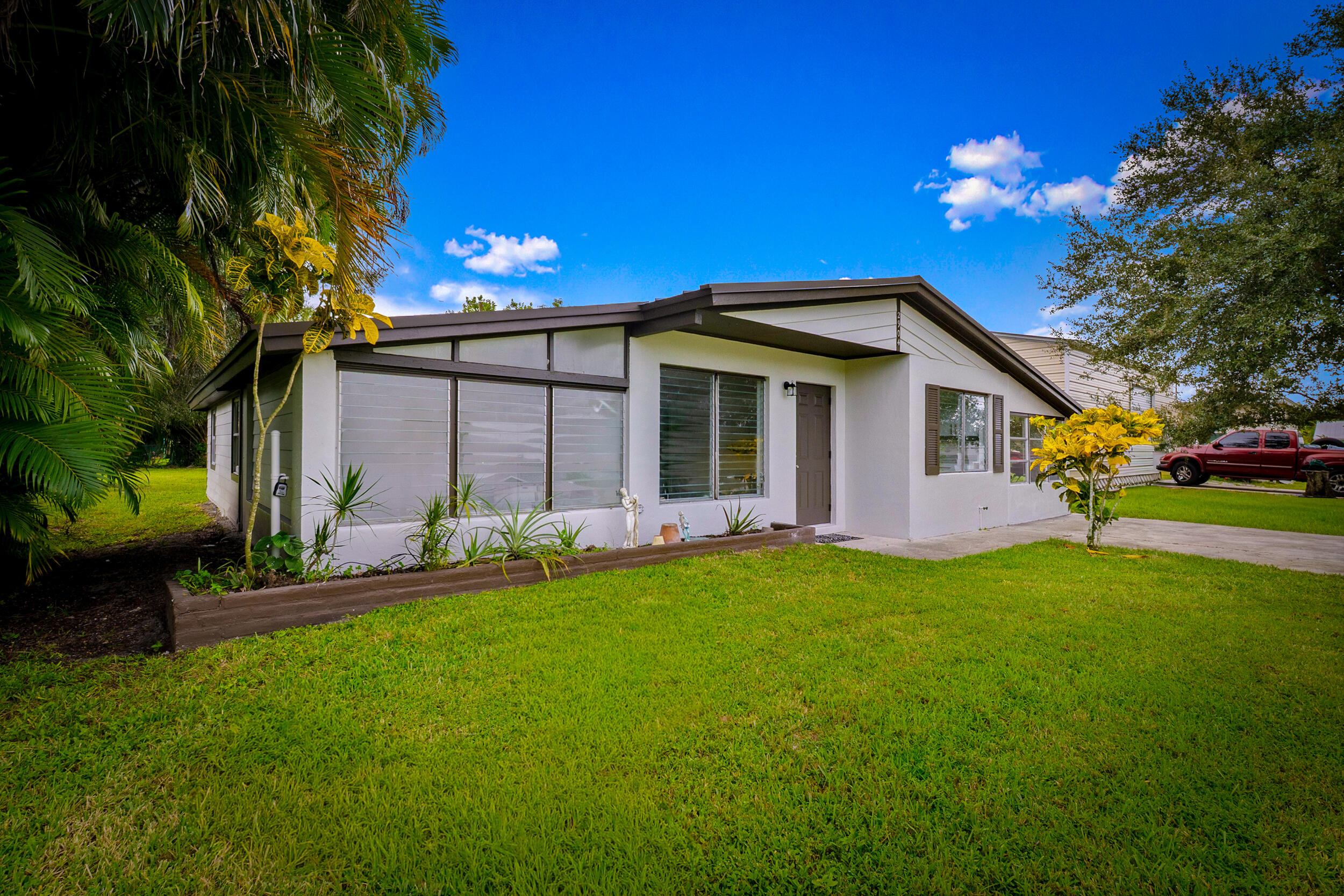 2904 Southeast Bamboo Street Stuart, FL 34997 - Photo 3 of 51 a front view of house with yard and green space